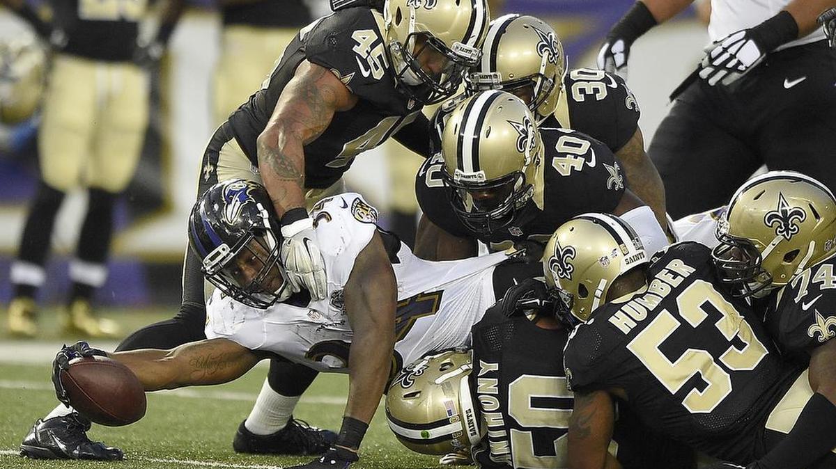 Former Coastal Carolina and Baltimore Ravens running back Lorenzo Taliaferro (34) looked for extra yardage in an NFL preseason game in Baltimore on Aug. 13, 2015.