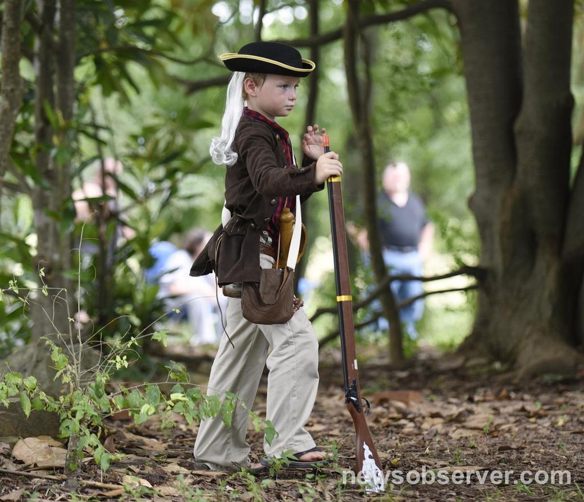 Benjamin Rankin, 6, watches a re-enactment of the House in the Horseshoe Battle in Sanford, N.C. on Sunday, August 7, 2016. Rankin's grandpa and uncles are Civil War re-enactors.