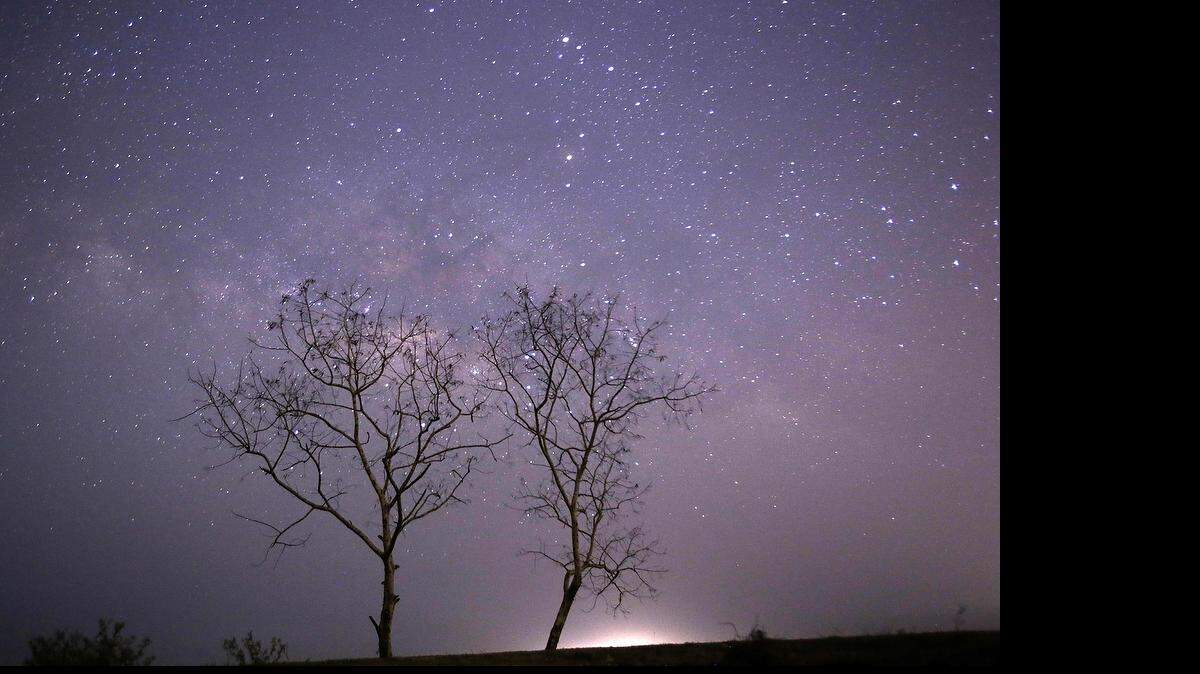 
This long-exposure photograph taken on April 23, 2015 on Earth Day shows Lyrids meteors shower passing near the Milky Way in the clear night sky of Thanlyin, nearly 14miles away from Yangon.
