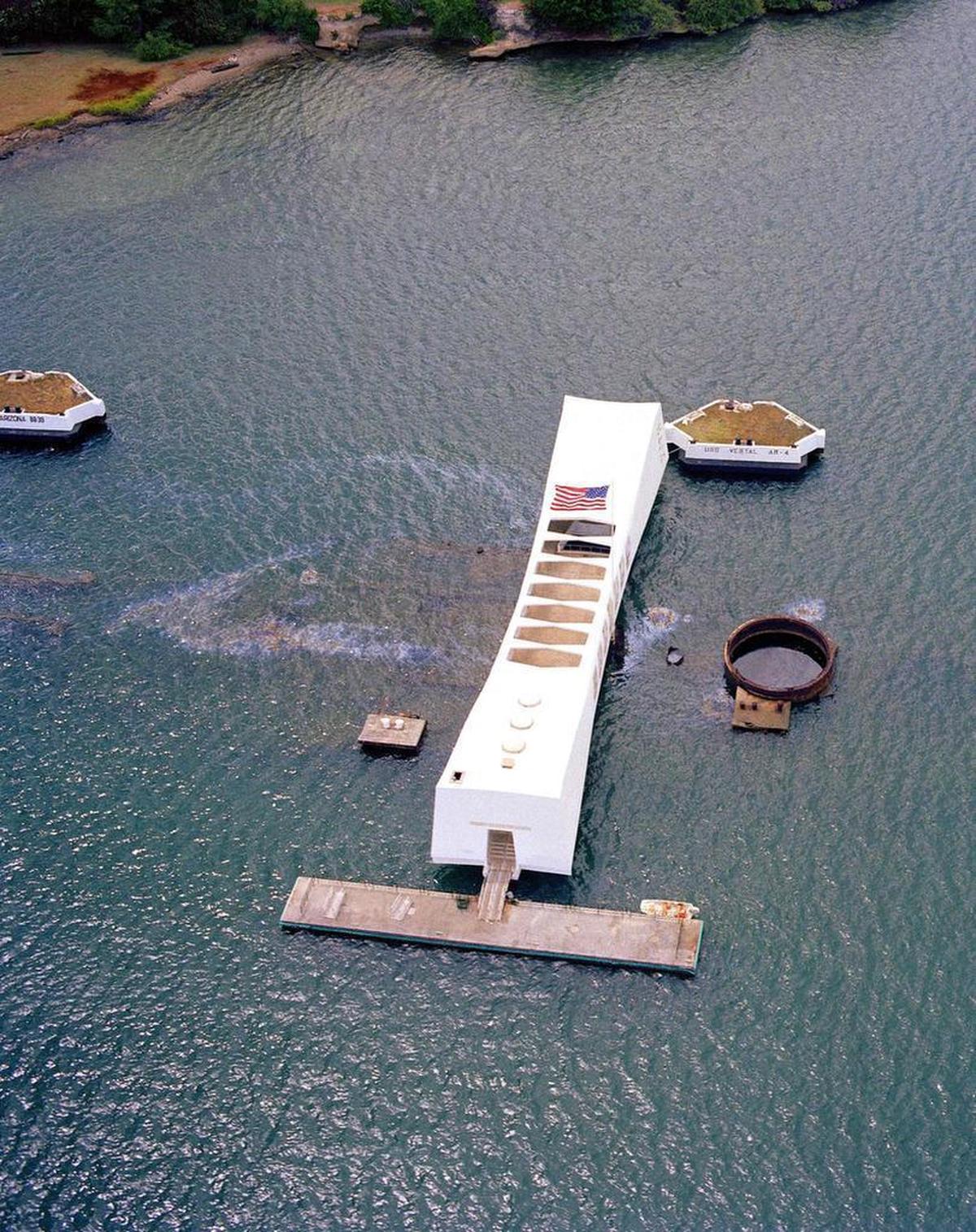 This June 15, 1984 US Navy handout photo shows an aerial view of the USS Arizona Memorial in Pearl Harbor Hawaii. Seventy-five years after Japan’s surprise attack on Pearl Harbor killed 2,403 Americans, the military personnel who died in the attack will be profoundly remembered, and the USS Arizona, which lies at the bottom of that harbor as a permanent memorial, will be visited. Later this month, Japanese Prime Minister Shinzo Abe will himself visit the U.S. naval base at Pearl Harbor with President Obama. He is the first Japanese leader to do so.