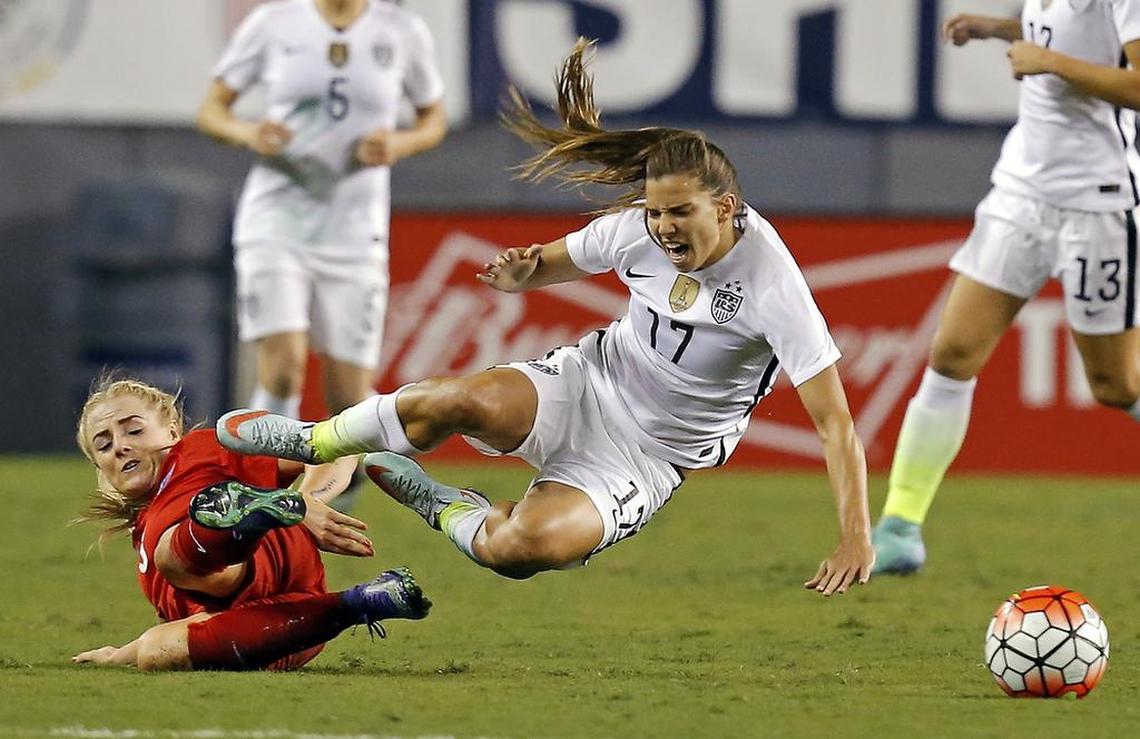 United States’ Tobin Heath (17) reacts to a tackle by England’s Alex Greenwood during the first half of a SheBelieves Cup women’s soccer match Thursday, March 3, 2016, in Tampa, Fla.