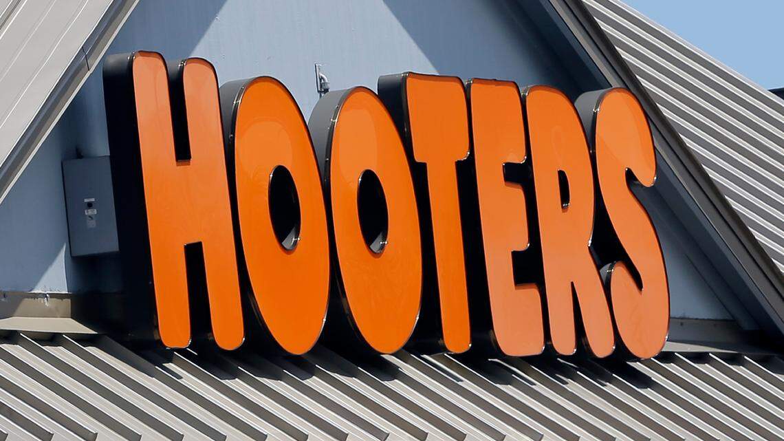 This photo taken Thursday, July 27, 2017, shows a Hooters sign at a restaurant.
