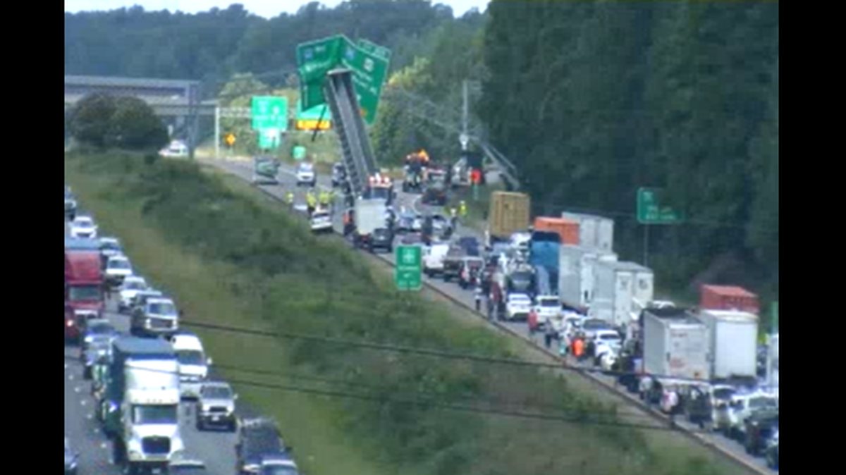 A tractor-trailer bed got stuck against a road sign on Interstate 64 in Virginia, shutting down traffic for hours, state officials said.