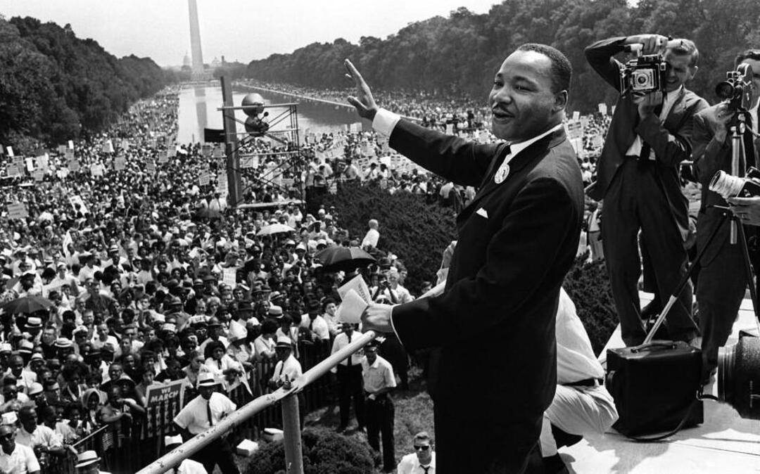 This August 28, 1963 file photo shows Martin Luther King Jr. waving from the steps of the Lincoln Memorial to supporters on the Mall in Washington, DC, during the "March on Washington".