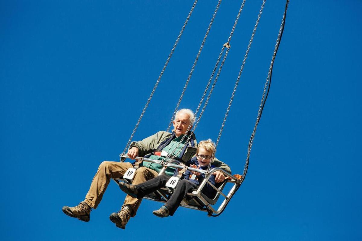 JB Marr, left, and Quinn O’Keefe, right, enjoy a ride on the midway during the final day of the North Carolina State Fair in Raleigh, N.C. on Sunday, Oct. 23, 2016.
