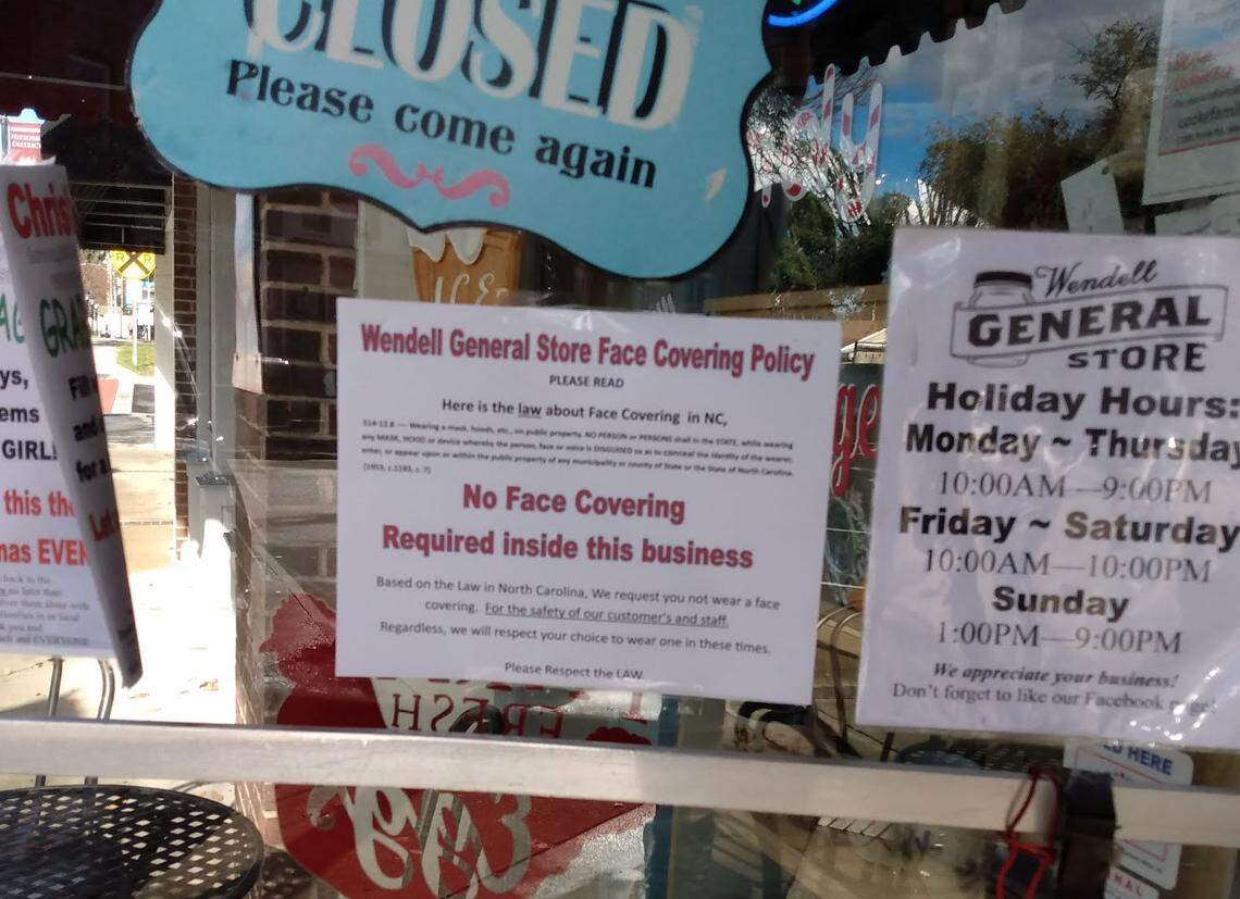 A sign on the door of the Wendell General Store in downtown Wendell tells customers not to wear masks inside “for the safety of our customers and staff.”