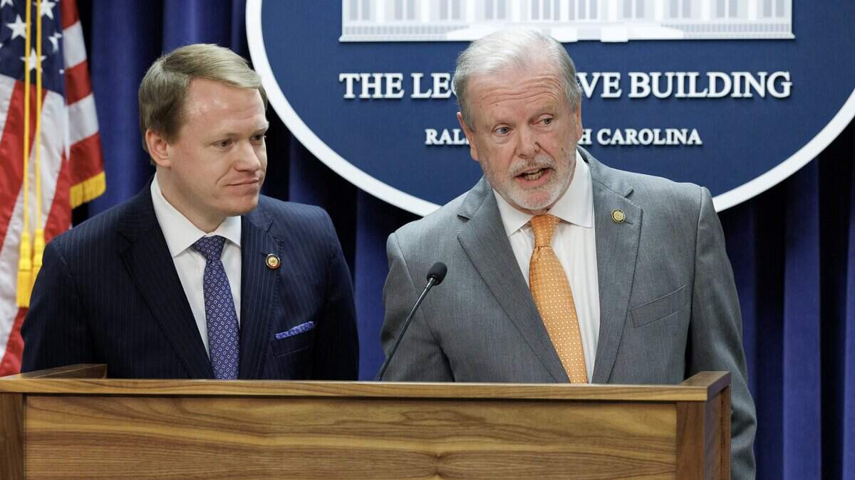 Senate leader Phil Berger answers a question while standing alongside House Speaker Destin Hall during a press conference to announce a state budget deal at the Legislative Building on May 12, 2026, in Raleigh.