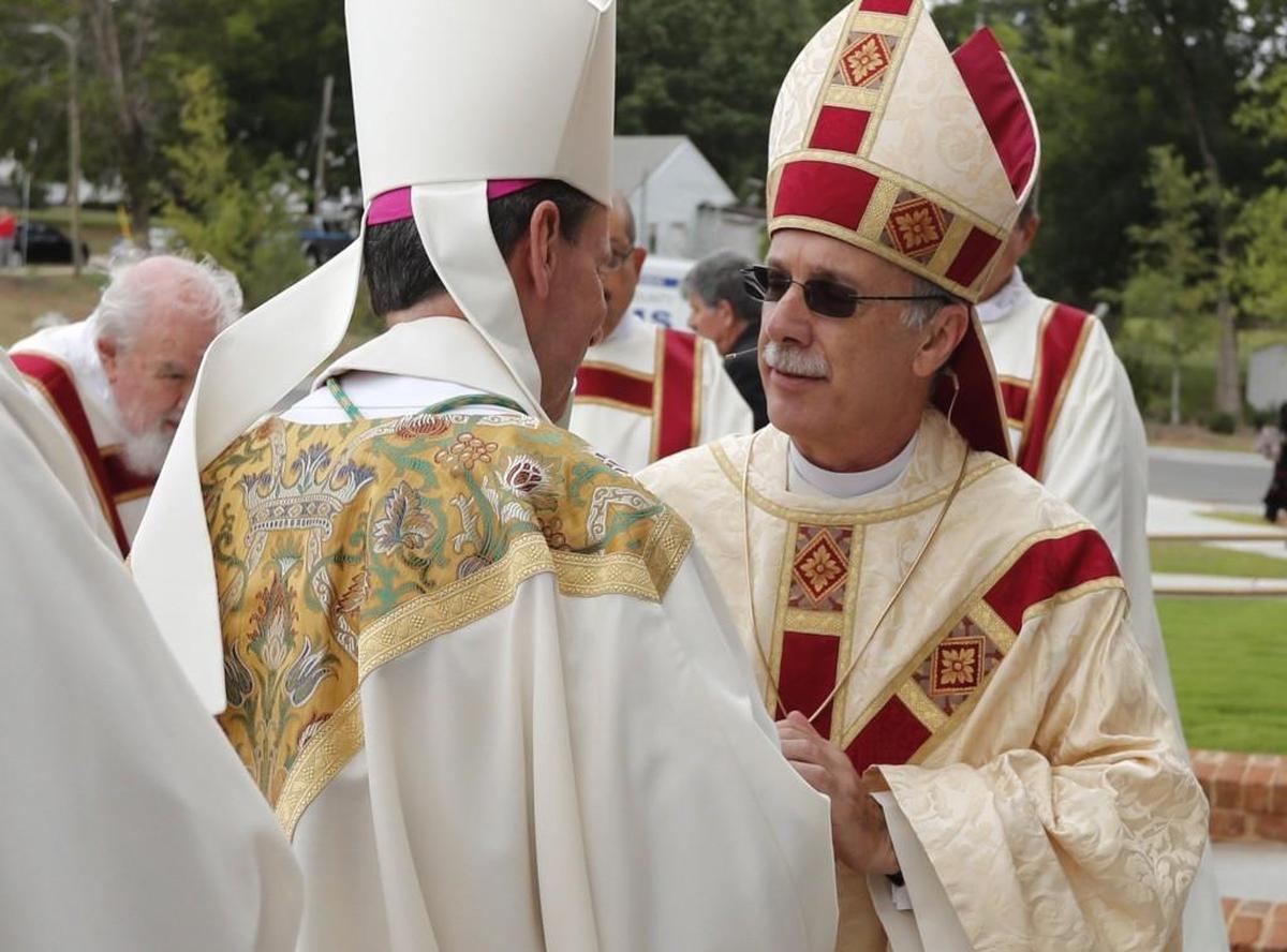 Bishop Luis Rafael Zarama, right, talks with the former bishop of the Diocese of Raleigh Michael Burbidge before his installation August 29, 2017. Zarama has joined with the U.S. Conference of Catholic Bishops in criticizing the dismantling of the Deferred Action for Childhood Arrivals program.
