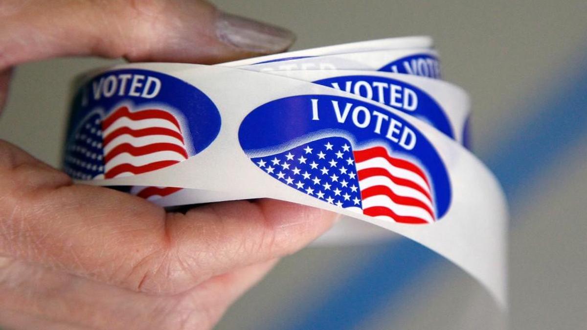 A poll worker holds the “I voted” stickers at Penny Rd. Elementary School in Cary,.