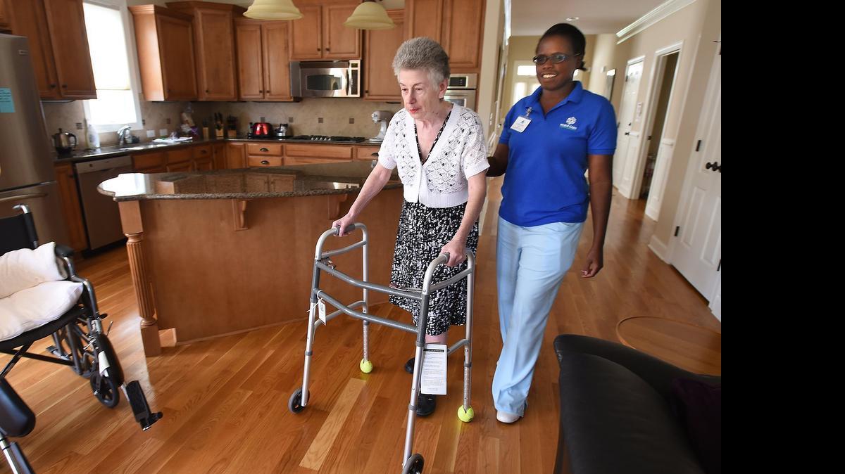 
Christine Boone (right) of Nurse Care NC carefully watches as Susan uses her walker at her Chapel Hill home Friday. Health care workers like Boone are paid just above minimum wage and have huge responsibilities in their work. Medicaid reimbursements are low and it makes a living wage difficult for these workers who care for the infirmed and elderly. 
