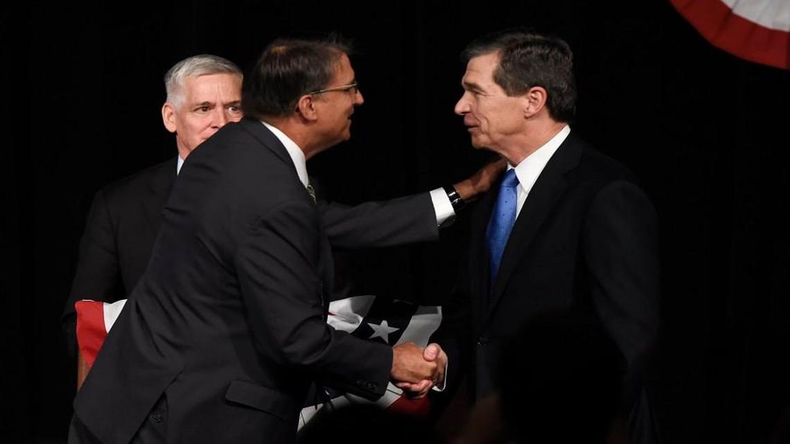 Gov. Pat McCrory (left) and Attorney General Roy Cooper greet each other after a debate in June.