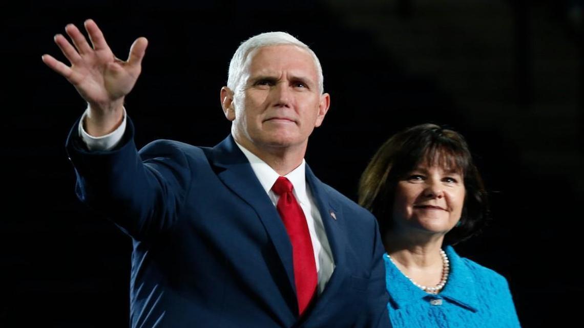 Republican vice-presidential candidate, Indiana Gov. Mike Pence, accompanied by his wife, Karen, waves after speaking at Liberty University in Lynchburg, Va., Wednesday, Oct. 12, 2016.
