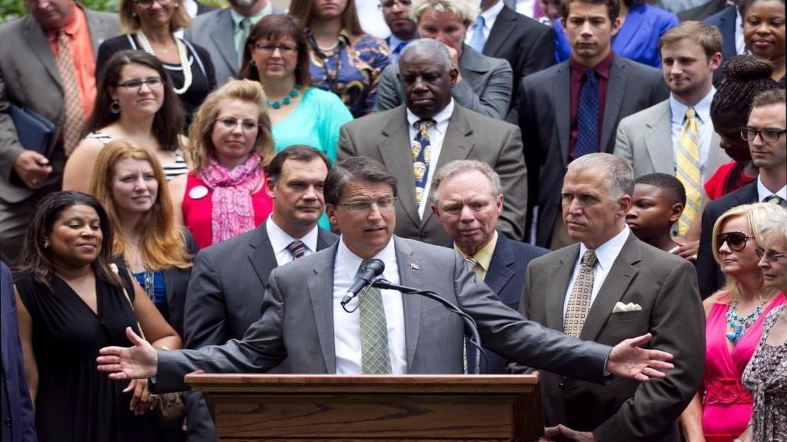 Governor Pat McCrory and House Speaker Thom Tillis (right), flanked by teachers, education administrators, and lawmakers announced legislation that will give teachers a five percent raise, does not require them to give up their tenure, and will not cut teacher assistant positions during a press conference at the Executive Mansion on Wednesday, June 25, 2014 in Raleigh, N.C.