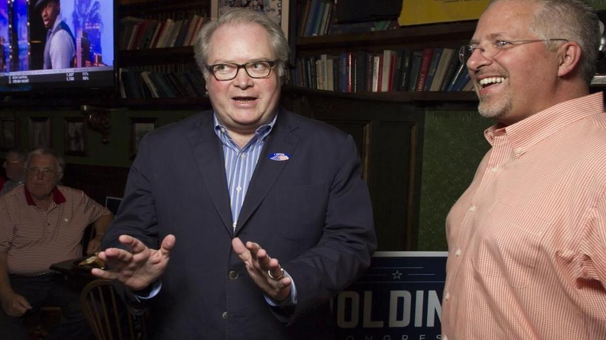 Congressman George Holding, left, talks with Duane Cutlip upon his arrival at the Hibernian in North Raleigh.