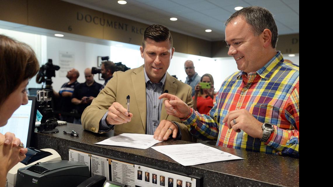 
Chad Biggs (left) and Chris Creech sign their marriage license before being married at the Wake County Courthouse in Raleigh, N.C. Friday, October 10, 2014. 
