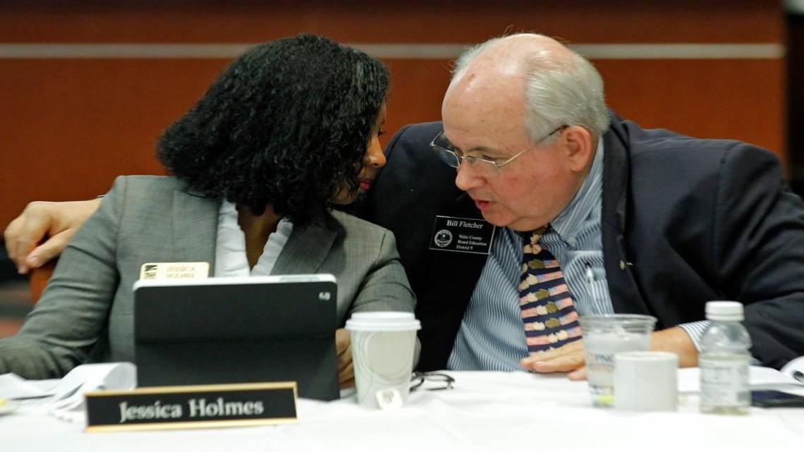Wake County Commissioner Jessica Holmes, left, and Wake County School Board member Bill Fletcher confer during a joint meeting of the commissioners and the school board on Jan. 26, 2015. Fletcher said the redrawn election maps “could create something that our community did not ask for and will not be happy with.”