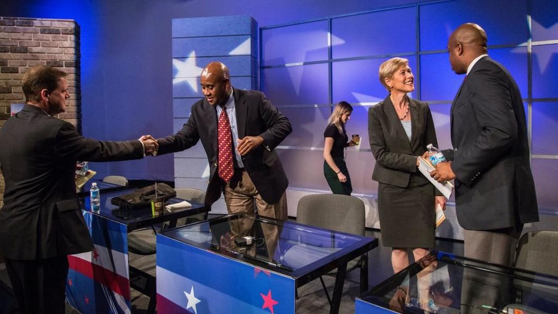 Democratic U.S. Senate candidates from left, Kevin Griffin, Ernest Reeves, Deborah Ross and Chris Rey shake hands Thursday following a televised debate at WRAL’s studio in Raleigh.
