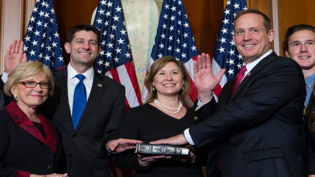 FILE – U.S. House Speaker Paul Ryan, R-Wis., administers the House oath of office to freshman lawmaker Rep. Ted Budd, R-N.C., during a mock swearing-in ceremony on Capitol Hill in Washington, Jan. 3, 2017. Budd is one of the Republicans in Congress whom national Democrats say they want to defeat in 2018. He responded with a campaign fundraising blast.