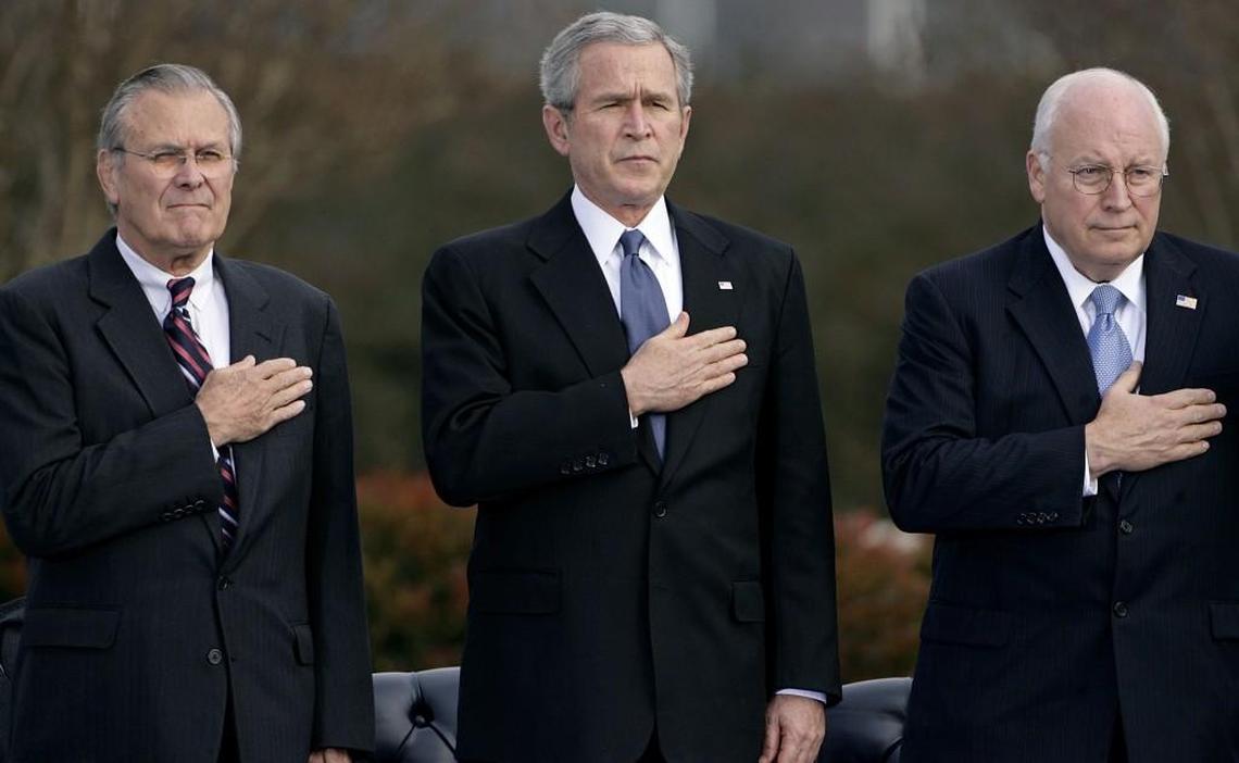 From left, Secretary of Defense Donald Rumsfeld, President George W. Bush and Vice President Dick Cheney attend the Armed Forces Farewell Tribute to Rumsfeld at the Pentagon December 15, 2006 in Arlington, Virginia. Praise was heaped on the outgoing secretary by Bush and Cheney and Rumsfeld used his farewell speech to call for an increase in military spending.