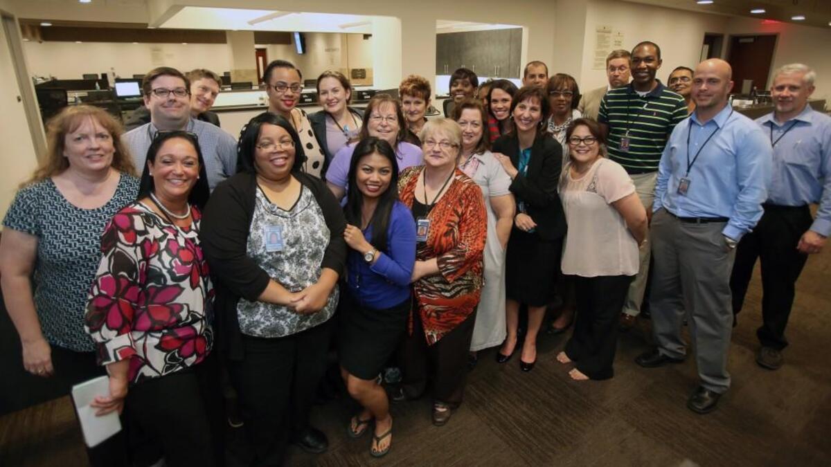 Former Wake County Register of Deeds Laura Riddick, in black dress at right, who resigned in March 2017, and her husband Matthew Eisley, third from left in back row, pose in the Register of Deeds office in the Wake County Justice Center in October 2014 when gay marriage was legalized in North Carolina and dozens of couples were married. Riddick was charged on Tuesday, Dec. 12, 2017 with embezzling more than $900,000. Three other former employees of the office were also indicted in the case involving $2.3 million missing from the Wake County Register of Deeds office.