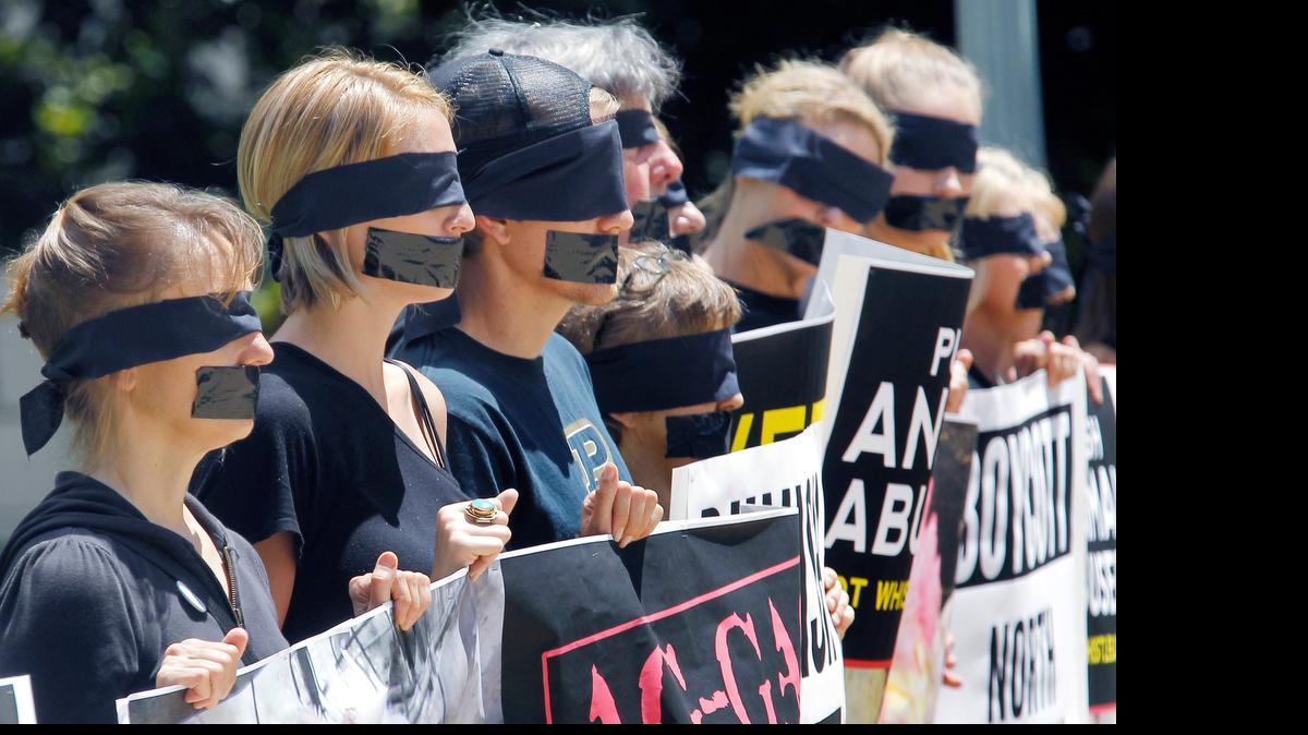 
About fifty protestors don blindfolds and gags as they gather at the N.C. Capitol in Raleigh to protest an Ag-Gag bill that would make it more difficult to report cases of animal mistreatment in this May 27, 2015, file photo.
