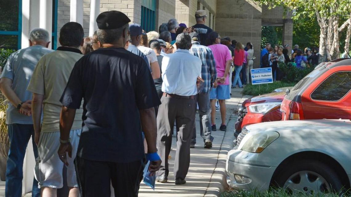 Voters wait patiently in line to vote at University City Regional Library Thursday morning. Thursday is the first day of early voting in Mecklenburg County.