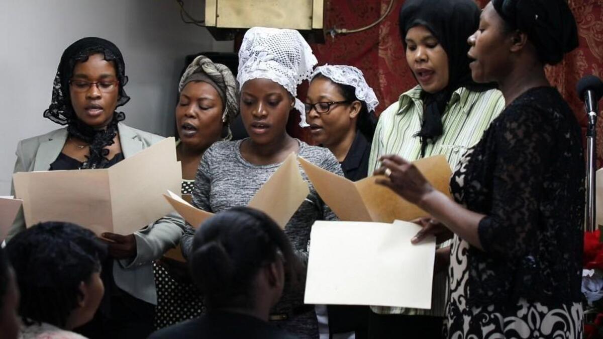 Haitian congregants perform songs for the "first Sunday" service at the First Haitian Baptist Church in Mt. Olive, NC on September 3, 2017.