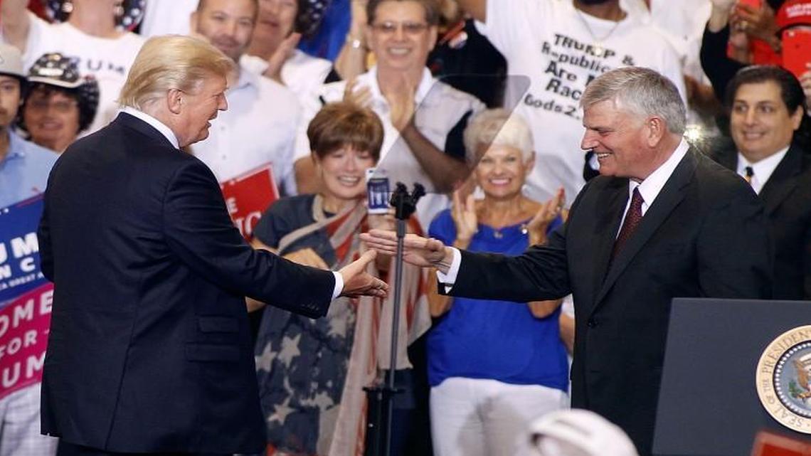Franklin Graham is greeted by President Donald Trump during a Trump rally on August 22, 2017 in Phoenix, Arizona.