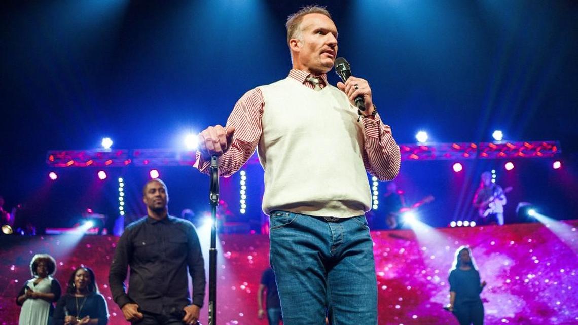 Pastor Ron Carpenter Jr., who founded Redemption church a quarter-century ago, leads a service at the flagship campus in Greenville.