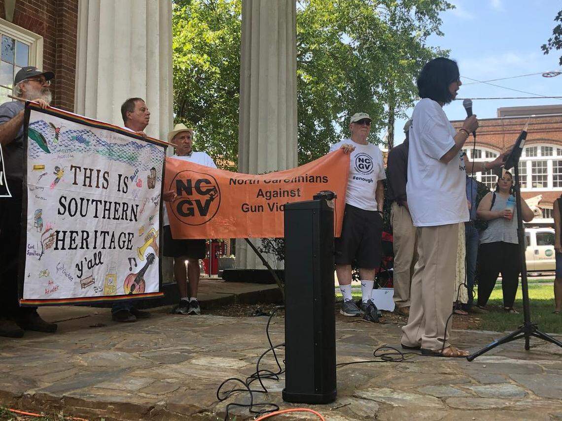 Renuka Soll of North Carolinians Against Gun Violence speaks to the crowd at Saturday’s rally in Hillsborough. Behind her, volunteers held up signs the entire event, including one that read, “This is Southern Heritage” and had no Confederate signage.