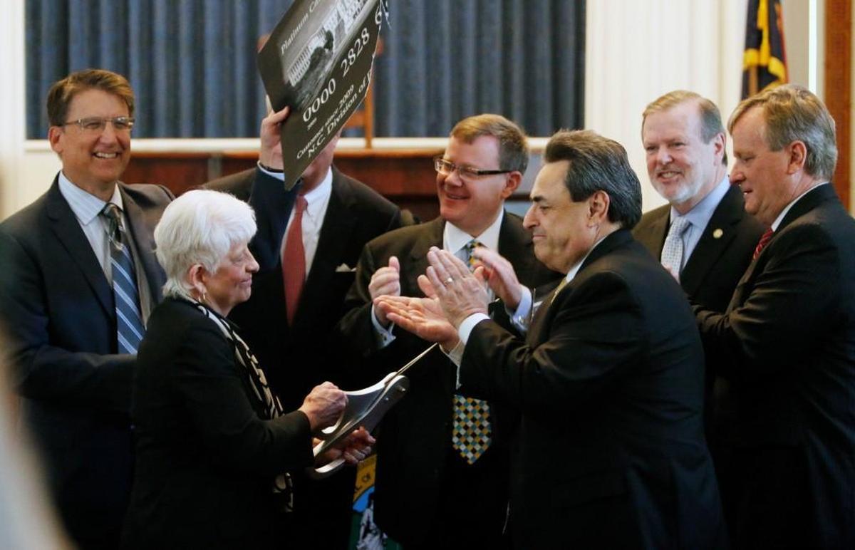 Gov. Pat McCrory and legislative leaders participate in a ceremonial cutting-up of a federal government credit card May 5, 2015, to announce the state had repaid its debt for unemployment insurance acquired during the 2008 financial crisis. A sharp reduction in jobless benefits accelerated the repayment.