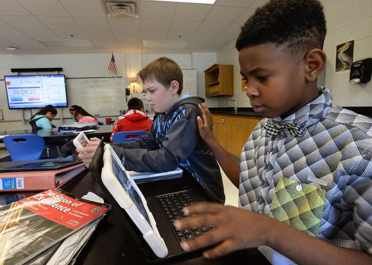 Students Jakari Garner, right, and Nate Guenzler during their science class at Carroll Middle School in 2016.