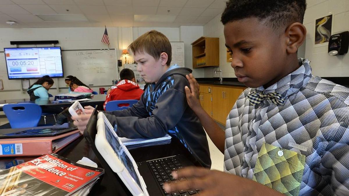 Students Jakari Garner, right, and Nate Guenzler during their science class at Carroll Middle School in 2016.