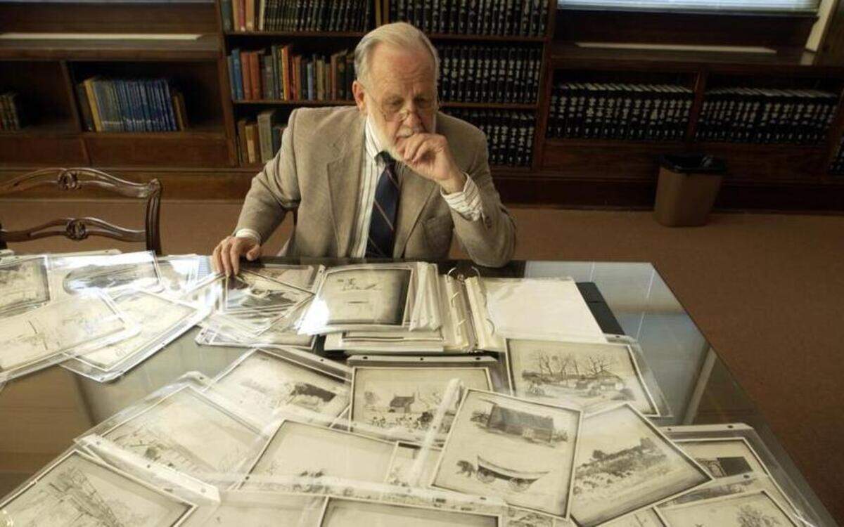 In this file photo historian H.G. Jones looks over his papers and sketches from his compilation of “Sketches in North Carolina USA: 1872 to 1878.” Jones died Oct. 14.