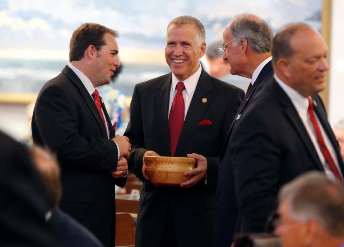 House Speaker Thom Tillis talks with Reps. John R. Bell IV, left, and Ted Davis, Jr., right, while passing out candy before the convening of the House during opening day of the General Assembly in 2014.