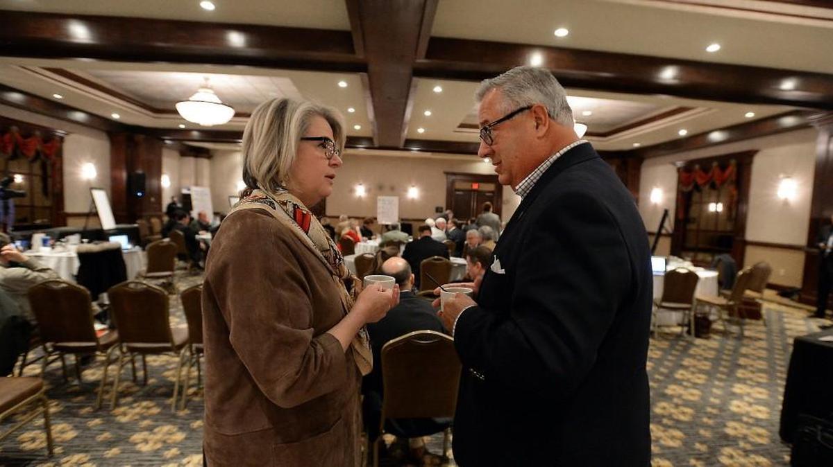 Margaret Spellings, then-UNC president-elect (left), speaks with UNC Board of Governors member Henry Hinton during a break in the board’s meeting at the Grandover Resort in Greensboro on Feb. 12, 2016.