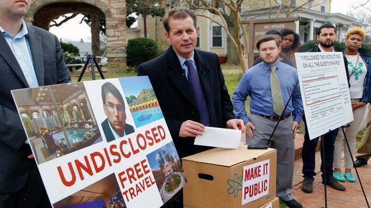 
Gerrick Brenner, center, with Progress NC Action, accuses Gov. Pat McCrory of having unreported conflicts of interests at a press conference outside the N.C. Ethics Commission headquarters in Raleigh on Monday.
