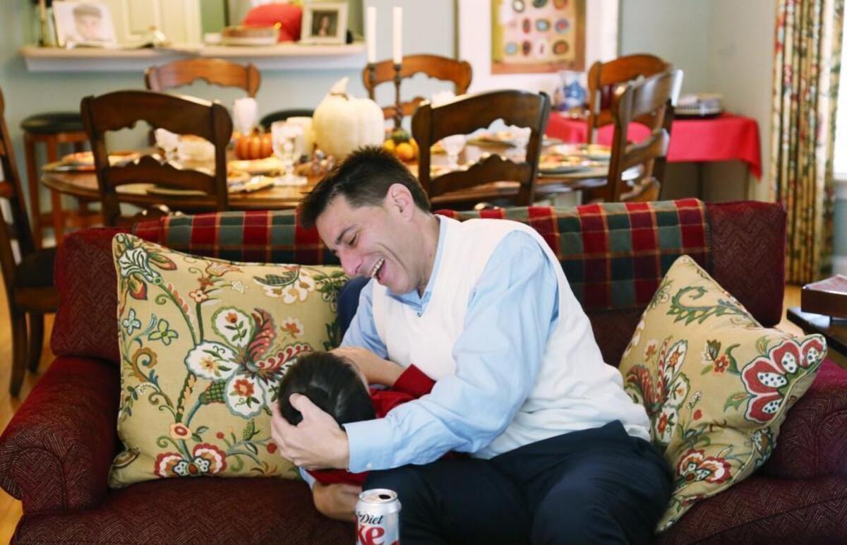 "You know what I am most thankful for?," Dallas Woodhouse, right, asks his youngest son, Cooper, 9, as they wrestle on the couch. "You!" he shouts before giving a squealing Cooper a kiss at Woodhouse's mother's Raleigh home on Thanksgiving, Nov. 23, 2017.