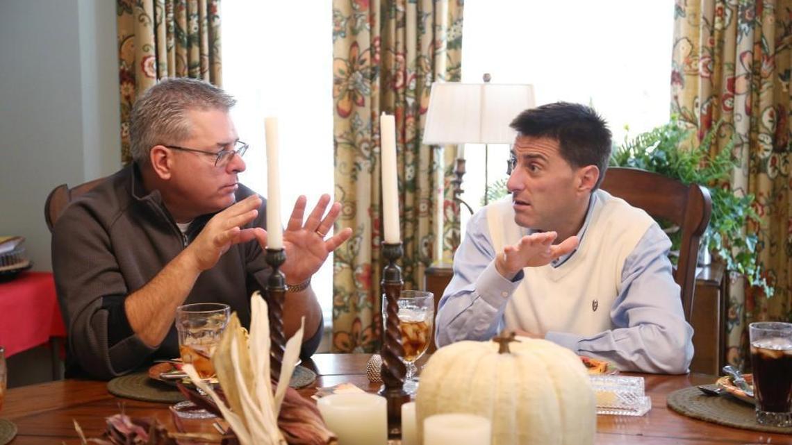Democrat Brad Woodhouse, left, and his Republican brother, Dallas Woodhouse, right, get into an animated discussion over the Thanksgiving meal at their mother's Raleigh home on Nov. 23, 2017. The brothers are known for their jousting over politics and the phone call their mother, Joyce, made when they were live on C-SPAN scolding them about their constant fighting.