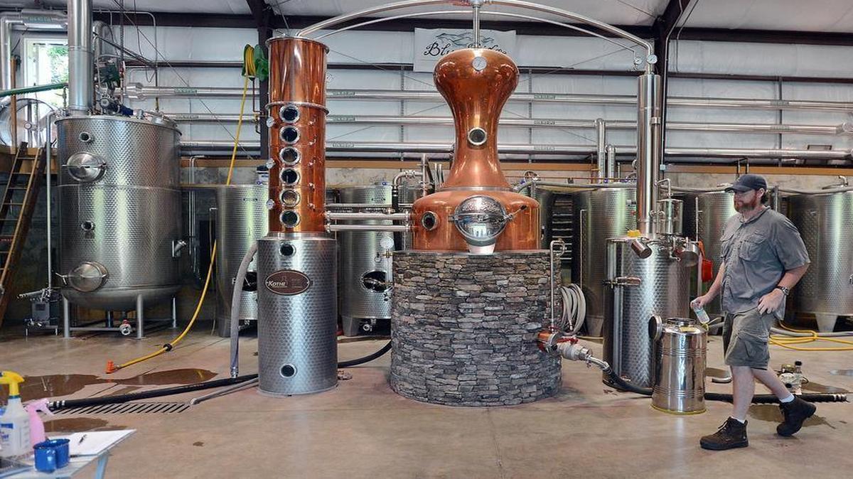 
Distiller Eric Meech walks past the distilling unit at Blue Ridge Distillery near Bostic, N.C. Wednesday, May 28, 2014. Legislation could allow distilleries to sell visitors one bottle per person, per year.
