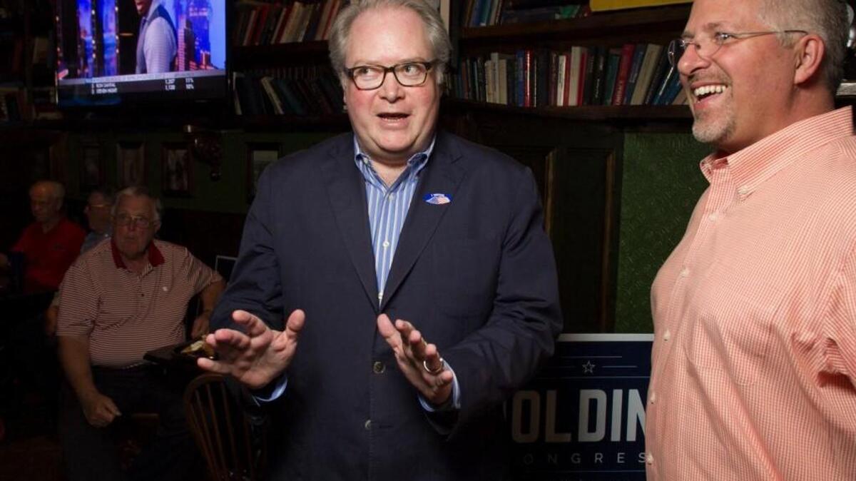 Congressman George Holding talks with Duane Cutlip upon his arrival on June 7, 2016, at the Hibernian in Raleigh, N.C.