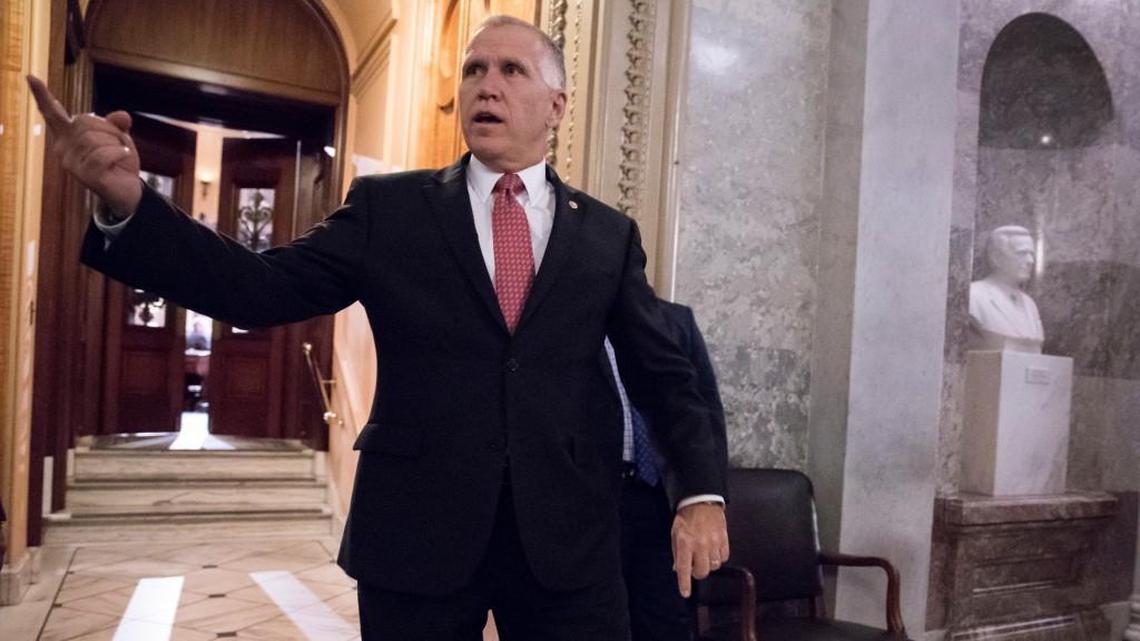 Sen. Thom Tillis, R-N.C., signals to a colleague on Capitol Hill in Washington on Nov. 27, 2017. Tillis planned to vote yes on the Senate’s tax plan.