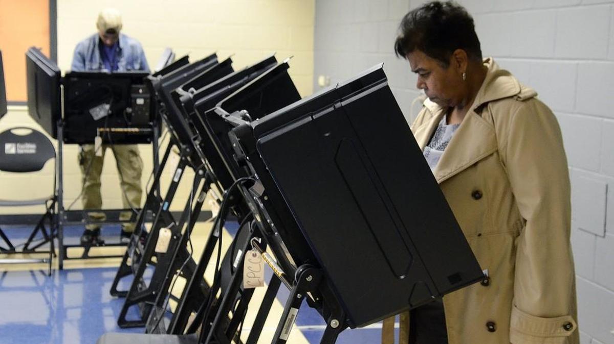 Donovan Cruz (left) and Jeanne Marshall vote at the Central Piedmont Community College Facilities Services building in Charlotte Thursday, March 3, 2016, the first day of early voting in North Carolina. It is the first NC election where a photo ID is required to vote.