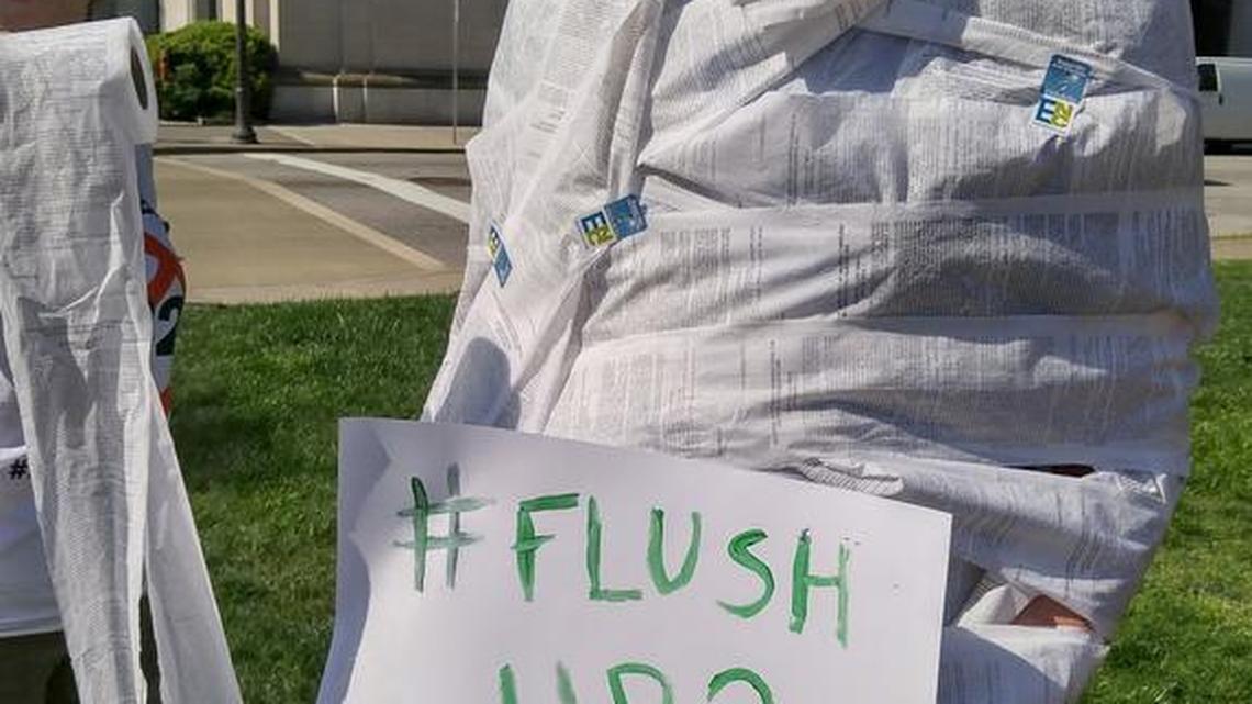 David McClay of ad agency McKinney shows off a mummy-style application of the company’s toilet paper with the text of HB2 on it, during a protest against the law Monday morning at the Capitol.