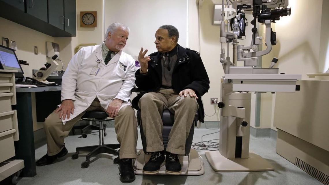 Optometrist Paul Archambault talks with U.S. Army veteran Kenneth Chavis during a glaucoma examination at the Fayetteville VA Medical Center. Optometry is one of several professions regulated in North Carolina by occupational licensing boards.