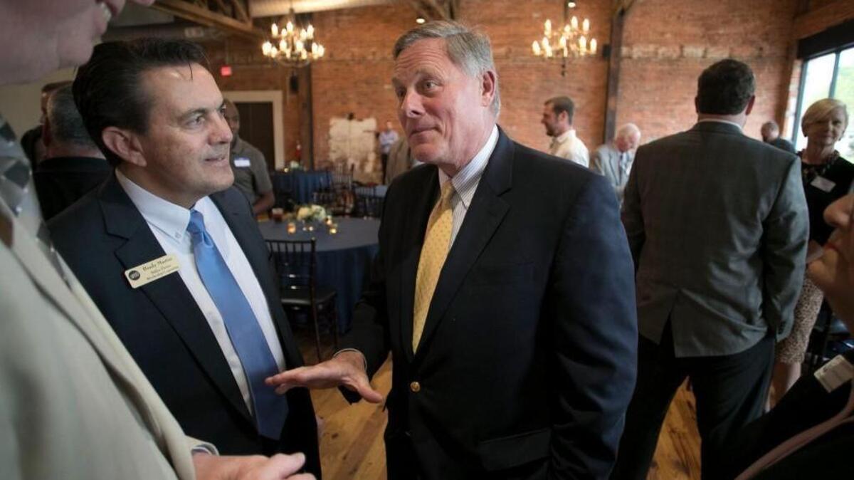 US Sen. Richard Burr talks with Brady Martin, left, of Halifax Electric during a reception in Burr’s honor on Tuesday, April 18, 2017, in Youngsville, N.C.
