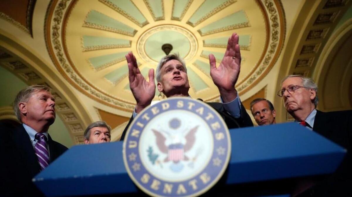 Sen. Bill Cassidy, R-La., center, speaks to the media, accompanied by Sen. Lindsey Graham, R-S.C., left, Sen. Roy Blunt, R-Mo., Sen. John Thune, R-S.D., and Senate Majority Leader Mitch McConnell of Ky., on Capitol Hill, Tuesday, Sept. 19, 2017, in Washington.