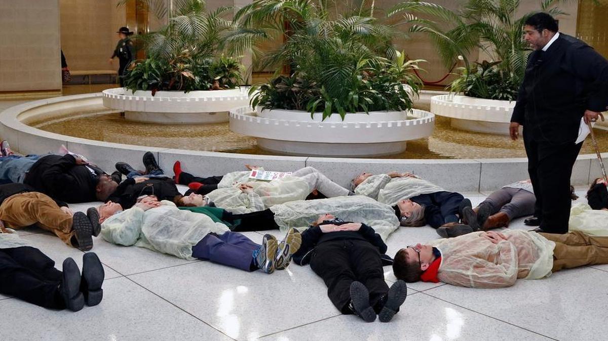 
Rev. William Barber, head of the NC NAACP, and fellow protesters stage a die-in at under the rotunda of the NC Legislature on February 12, 2015, to protest the state's continued denial of Medicaid expansion for hundreds of thousands of North Carolinians. Children’s advocates joined the cause on Thursday with their own protest at the Capitol.
