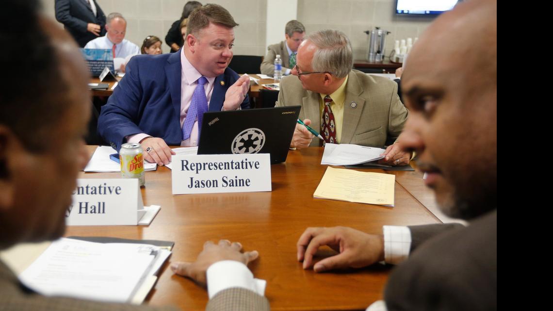 
Rep. Jason Saine, back left, and Rep. James Boles, back right, along with Rep. Larry Hall, front left, and Rep. Edward Hanes, Jr., front right, talk before the start of the House Rules, Calendar and Operations committee meeting in the Legislative Building in Raleigh, N.C., Wednesday, April 29, 2015. 
