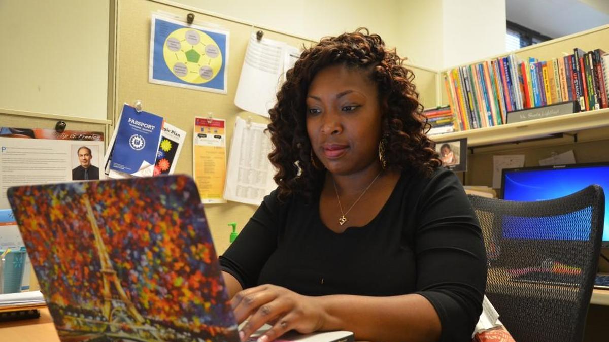 Shanta Lightfoot, senior administrator for middle school English language arts for Wake County Schools, works in her office. Lightfoot was a teaching fellow at N.C. State University before graduating in 2008.